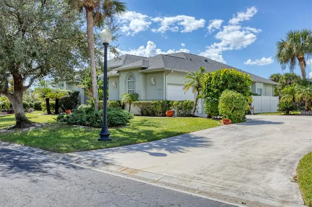 a view of a house with a yard and plants