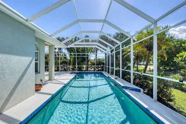 a view of a patio with table and chairs under an umbrella