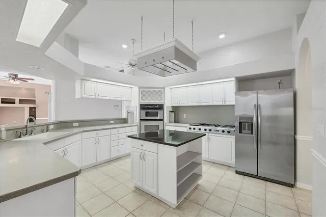 a kitchen with stainless steel appliances granite countertop a stove and a refrigerator