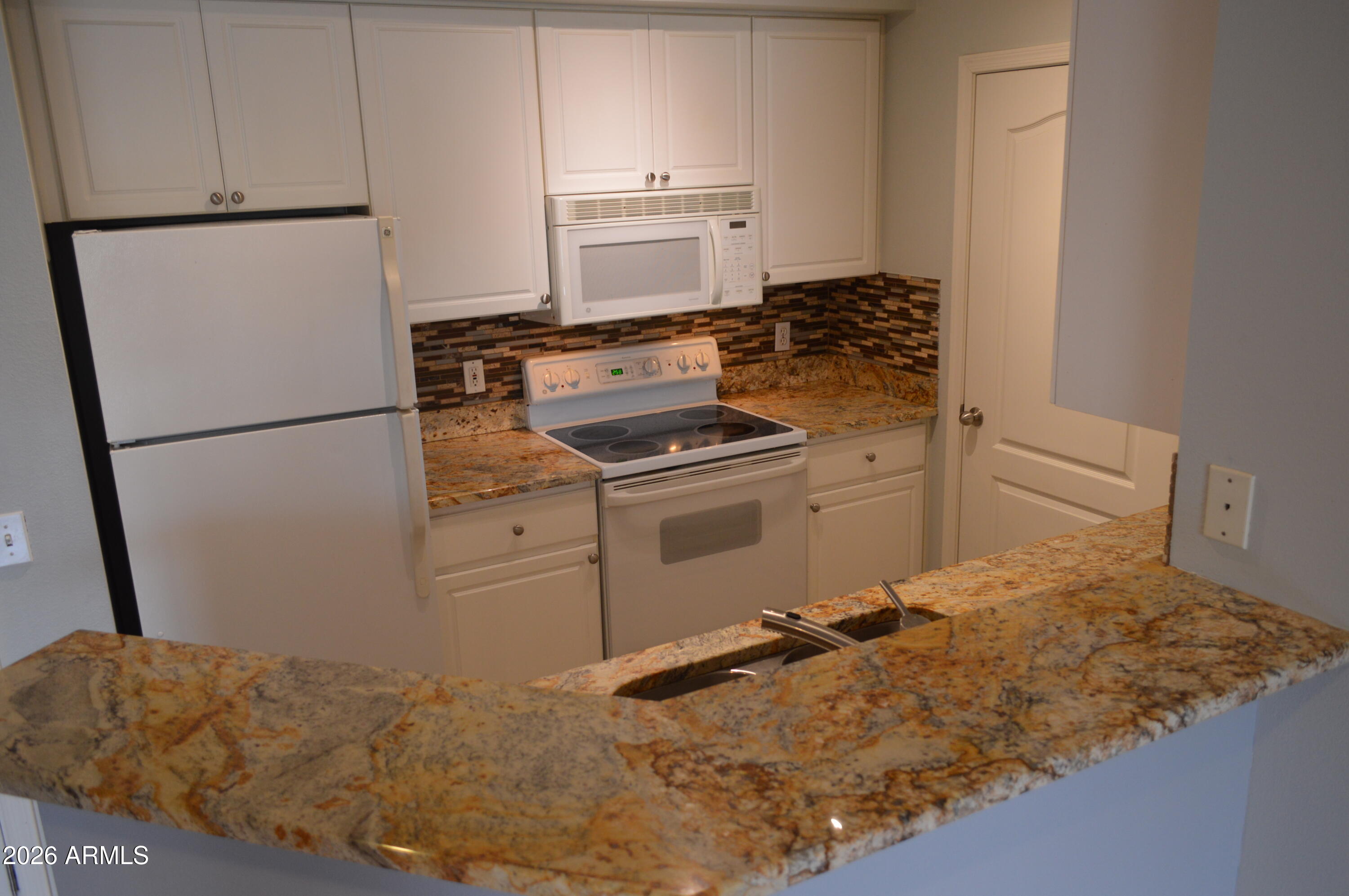 1701 East Colter Street, Unit 308 Phoenix, AZ 85016 - Photo 11 of 67 a kitchen with a refrigerator stove and cabinets