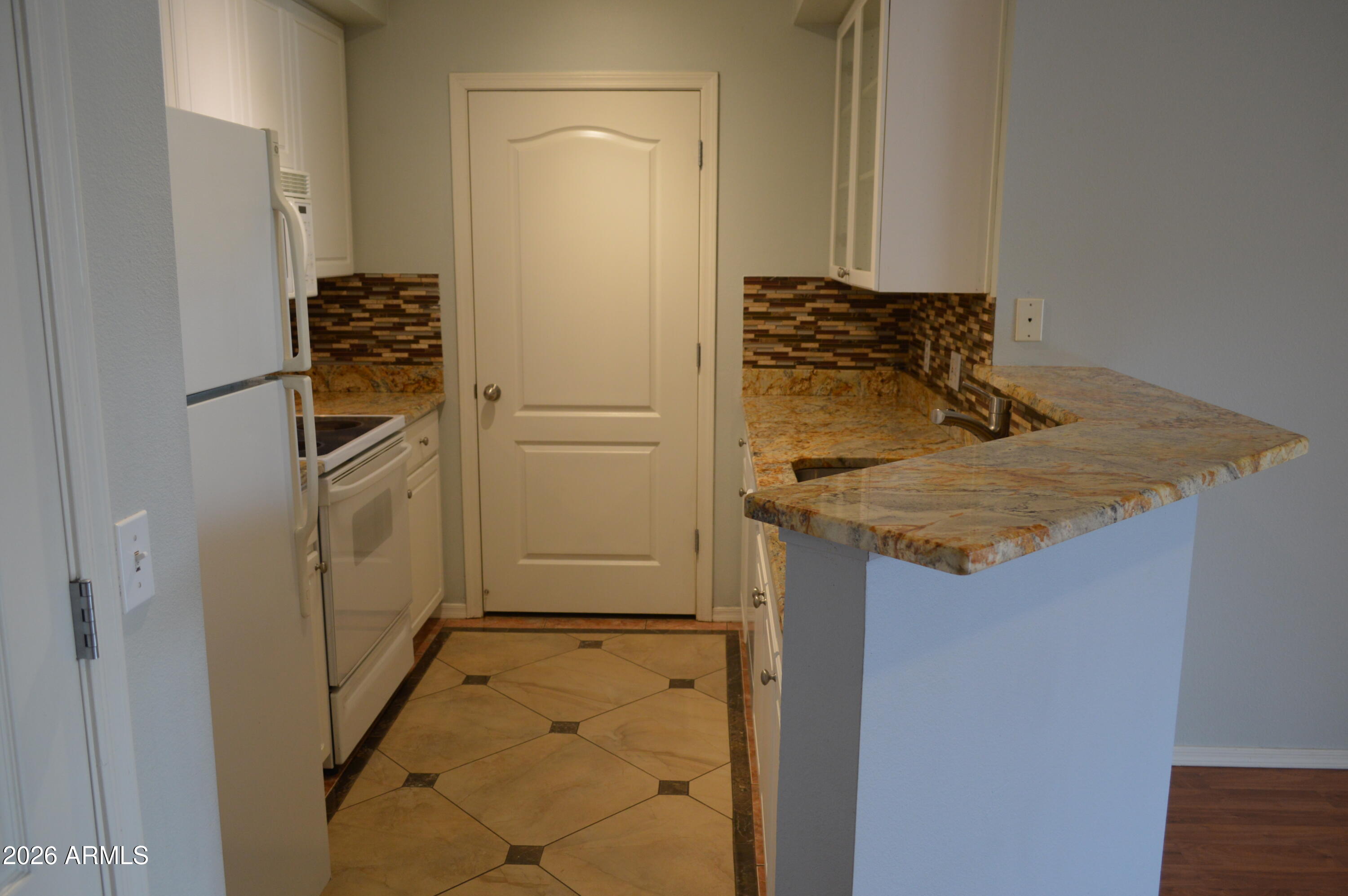 1701 East Colter Street, Unit 308 Phoenix, AZ 85016 - Photo 9 of 67 a bathroom with a granite countertop sink and washing machine
