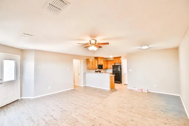 a view of a kitchen with a sink and a refrigerator