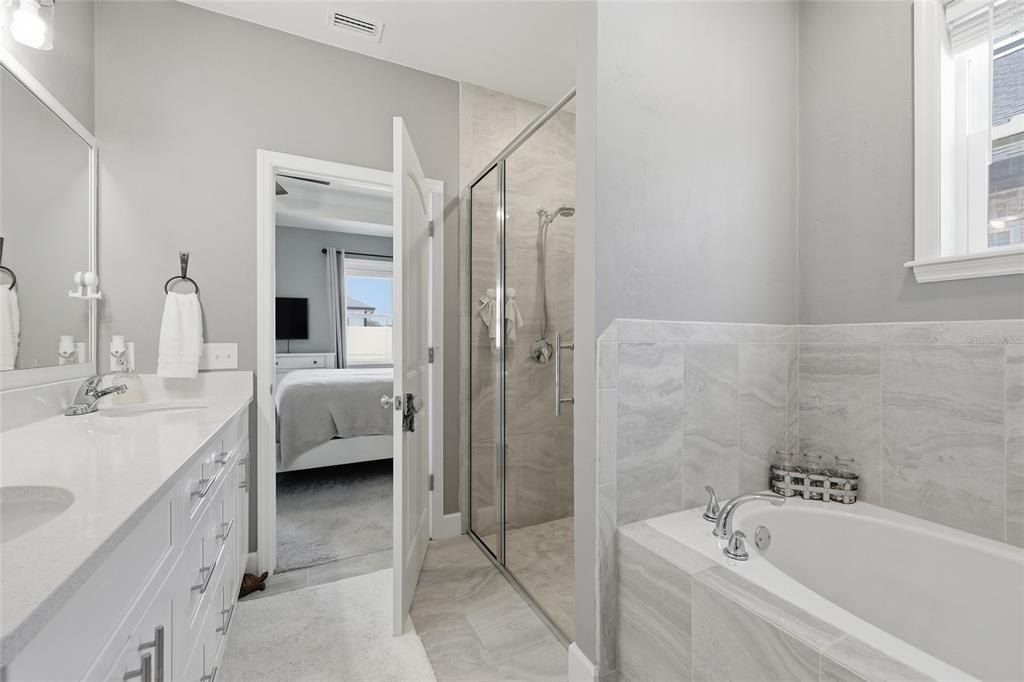 2168 Southwest 245th Terrace Newberry, FL 32669 - Photo 15 of 34 a en suite spacious bathroom with a tub double sink and window