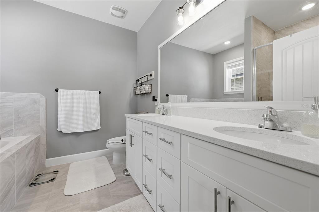 2168 Southwest 245th Terrace Newberry, FL 32669 - Photo 16 of 34 a bathroom with a sink toilet and a mirror