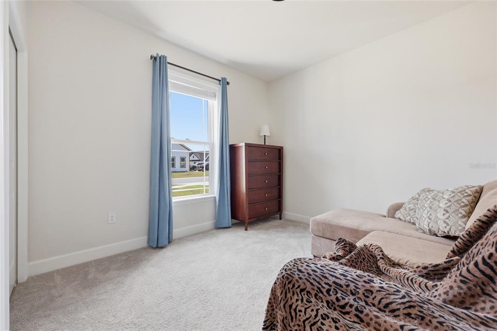 2168 Southwest 245th Terrace Newberry, FL 32669 - Photo 17 of 34 a bedroom with a bed and a dresser