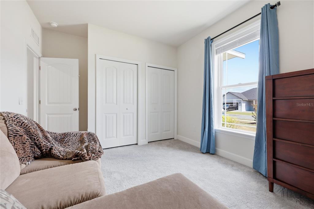 2168 Southwest 245th Terrace Newberry, FL 32669 - Photo 18 of 34 a living room with a couch and a walk in closet