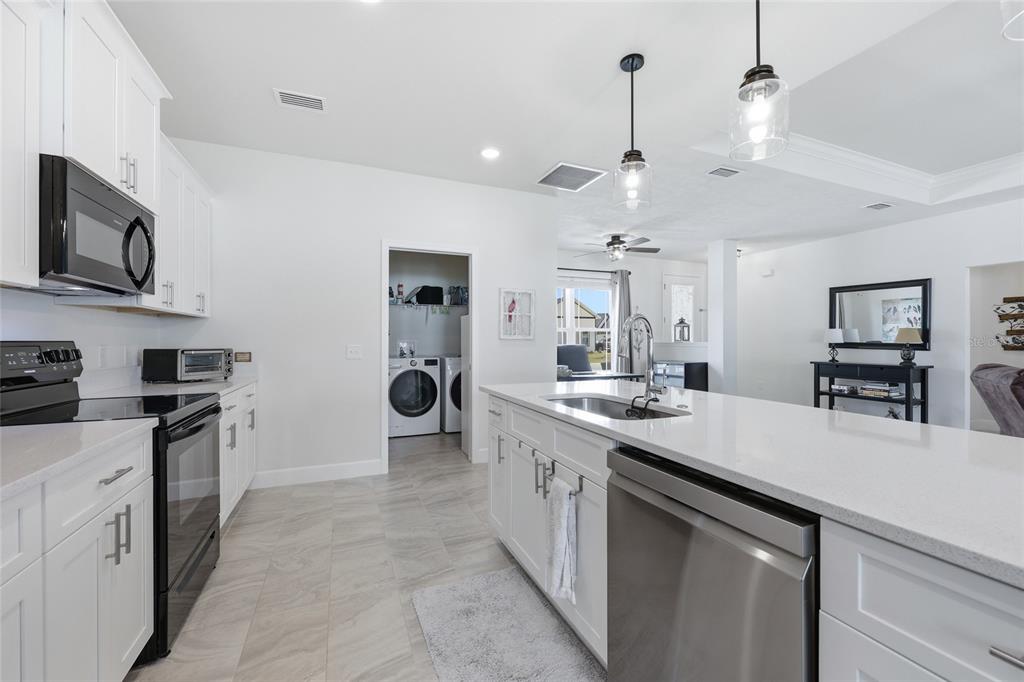 2168 Southwest 245th Terrace Newberry, FL 32669 - Photo 5 of 34 a kitchen with stainless steel appliances a sink stove and refrigerator