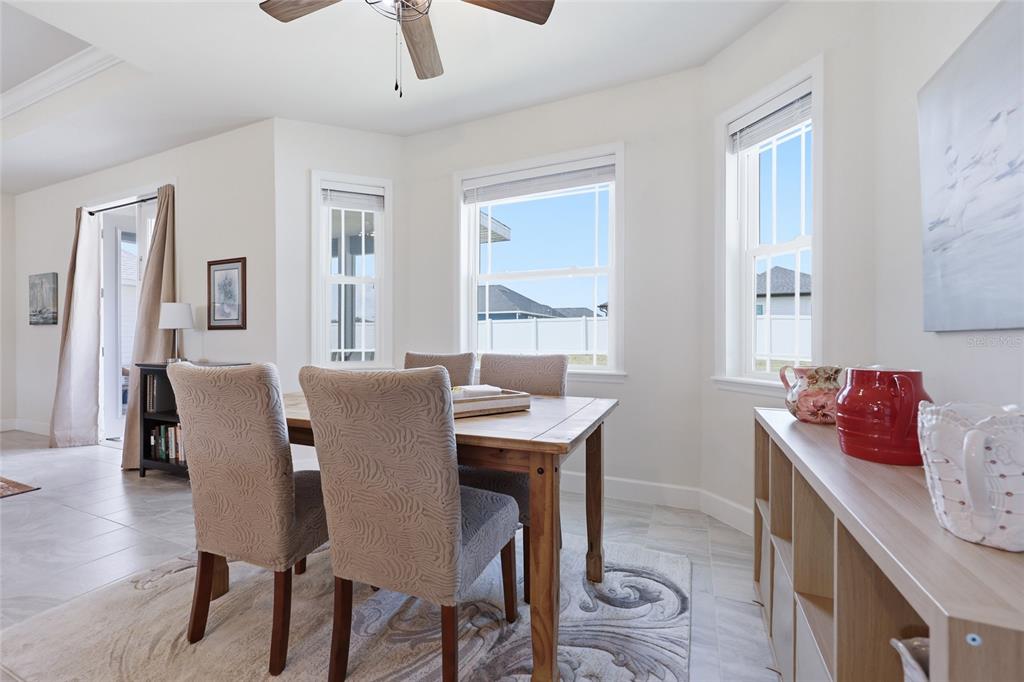 2168 Southwest 245th Terrace Newberry, FL 32669 - Photo 8 of 34 a view of a dining room with furniture and wooden floor