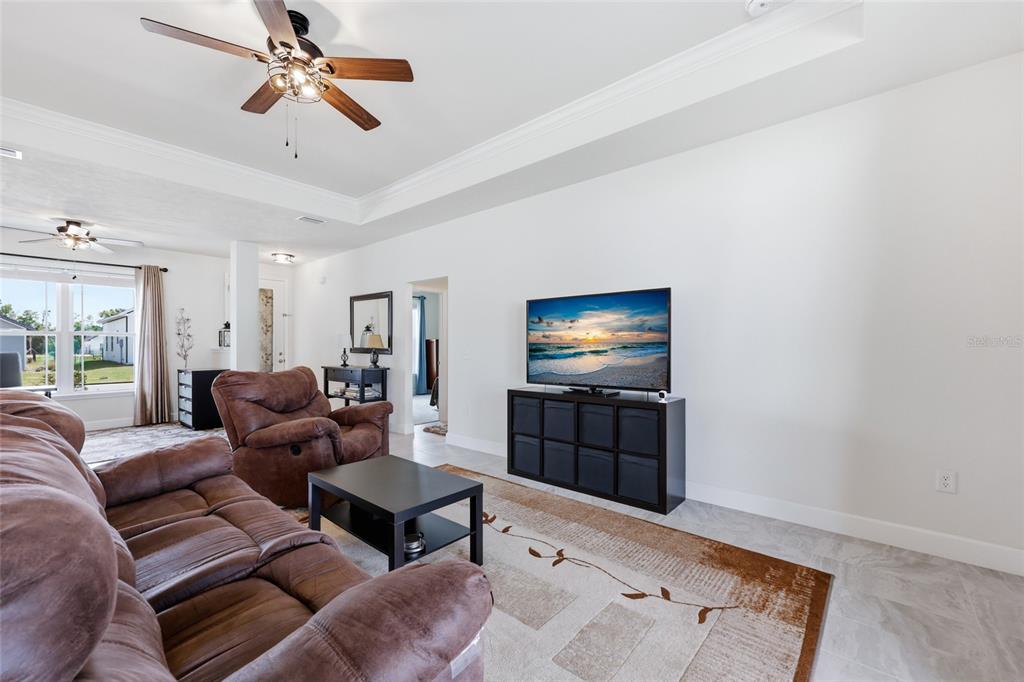 2168 Southwest 245th Terrace Newberry, FL 32669 - Photo 10 of 34 a living room with furniture and a flat screen tv
