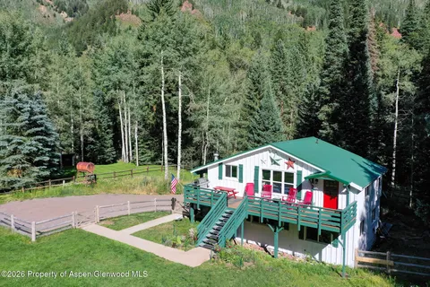 a front view of house with yard and swimming pool