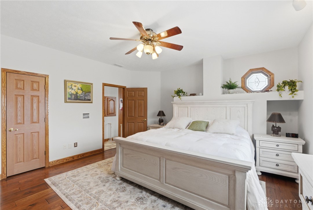 1540 Jasper Road Xenia, OH 45385 - Photo 28 of 91 This restful bedroom features warm wood flooring and a stylish ceiling fan.