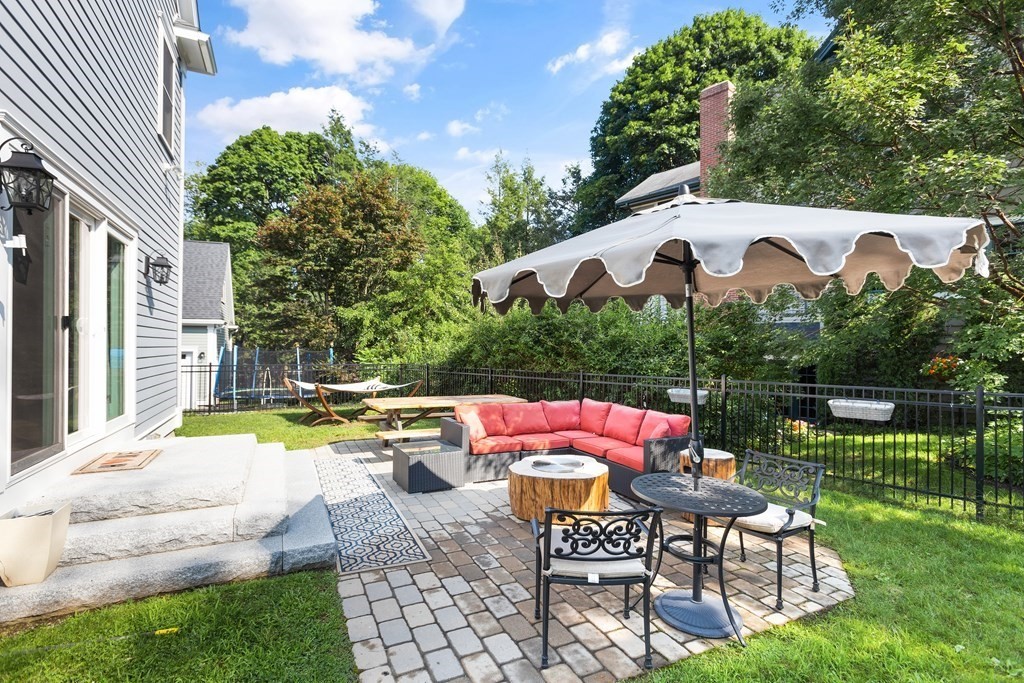 2 Cranston Road Winchester, MA 01890 - Photo 35 of 40 a patio with water fountain in front of a house