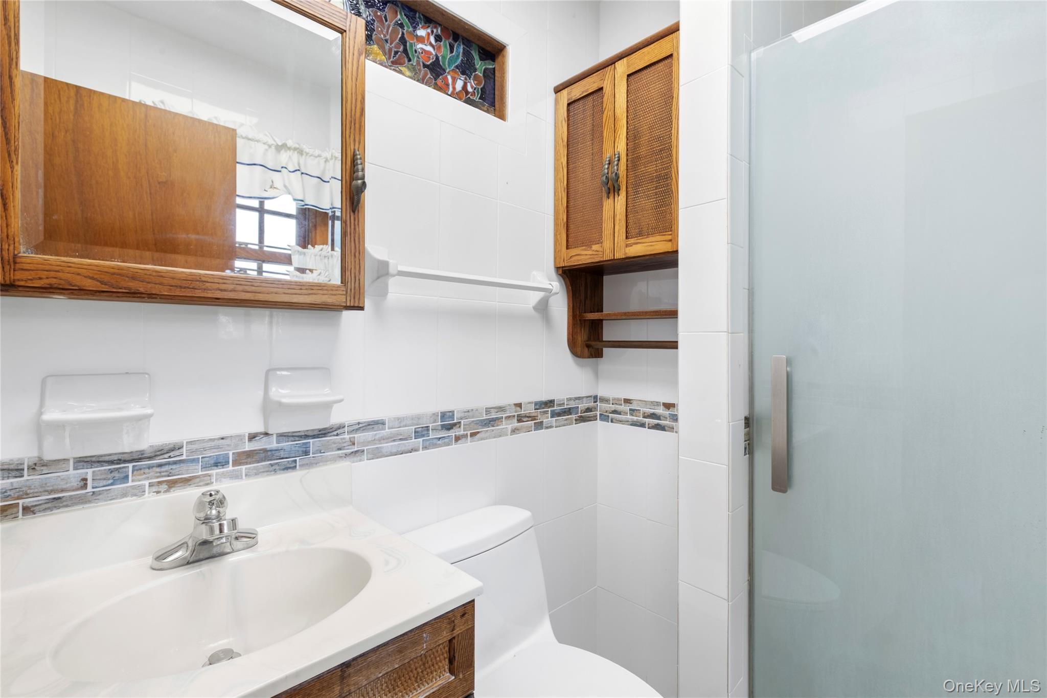 250 Paradise Point Road Southold, NY 11971 - Photo 10 of 24 a bathroom with a sink and a mirror