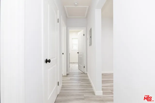 a view of a room with wooden floor and a window
