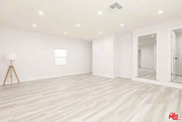 a bathroom with a granite countertop sink a toilet and a mirror