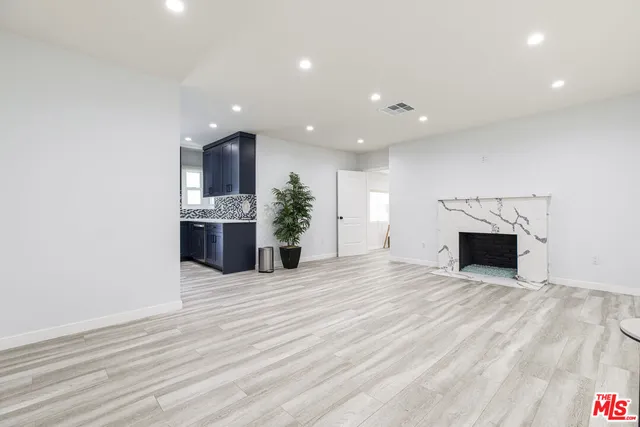 a kitchen with stainless steel appliances kitchen island granite countertop a stove a sink and a microwave