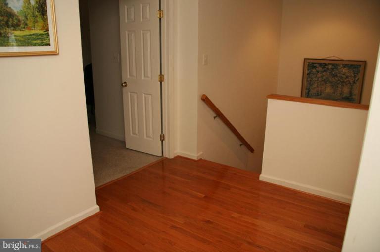 5876 Pimlico Road Baltimore, MD 21209 - Photo 22 of 29 a view of a hallway with wooden floor