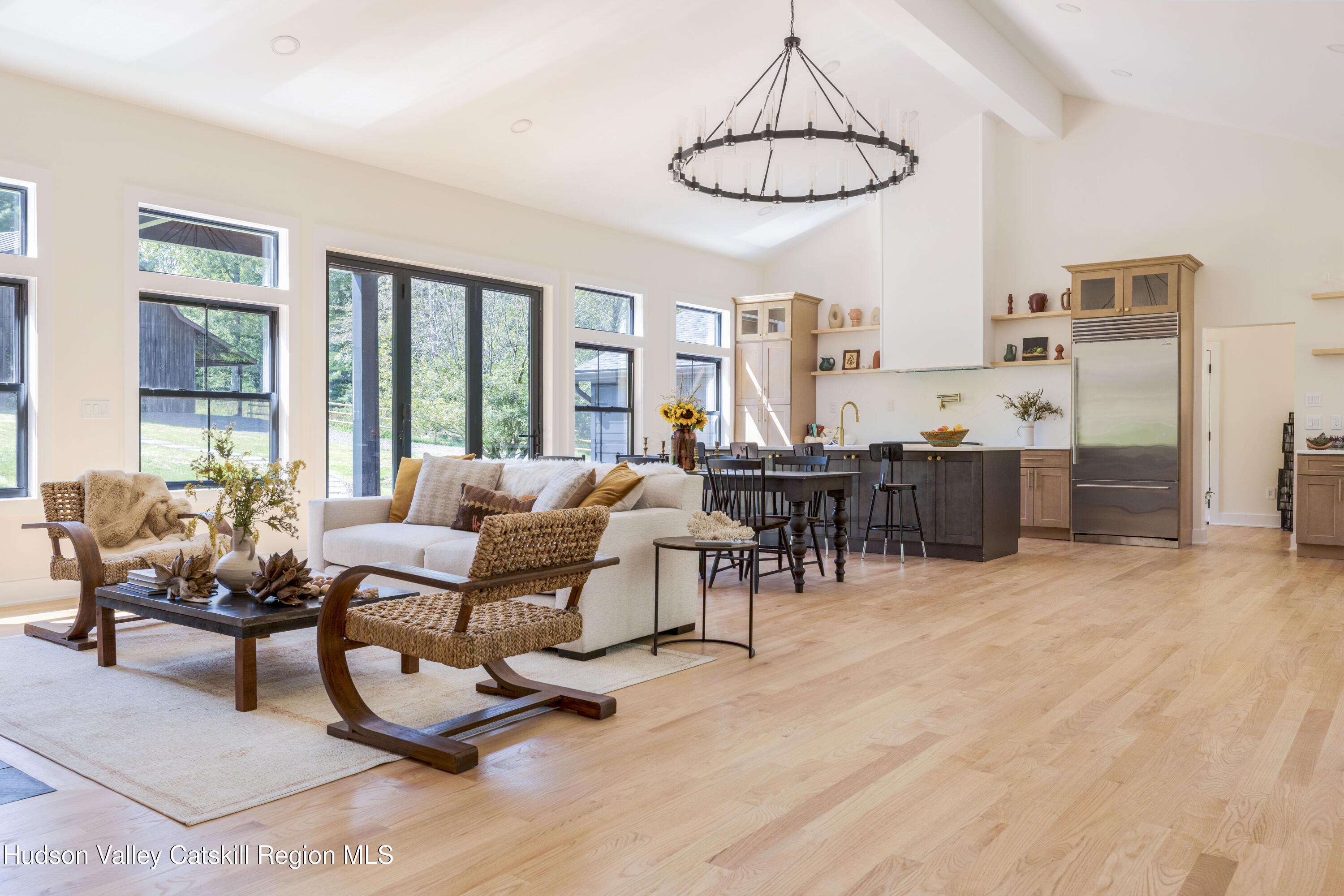 119 Mt Laurel Road Kerhonkson, NY 12446 - Photo 12 of 37 a living room with furniture and a dining table with kitchen view