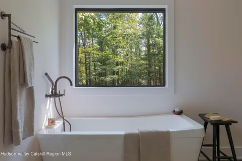 a bathroom with a bathtub and a window