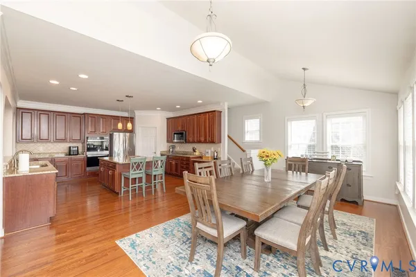 a kitchen with granite countertop wooden cabinets and a microwave oven