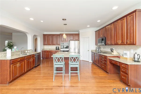 a kitchen with stainless steel appliances granite countertop a stove and a sink