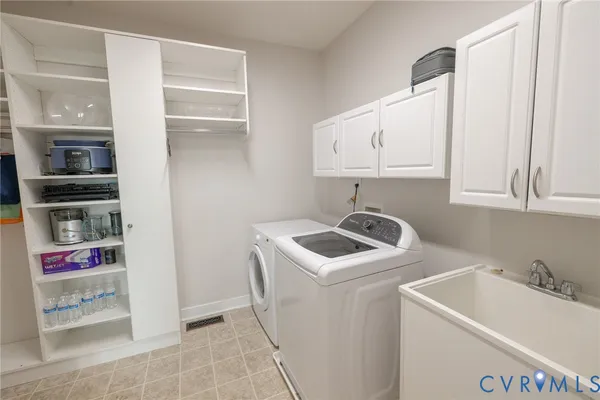 a bedroom with a large bed and a flat tv screen on dresser