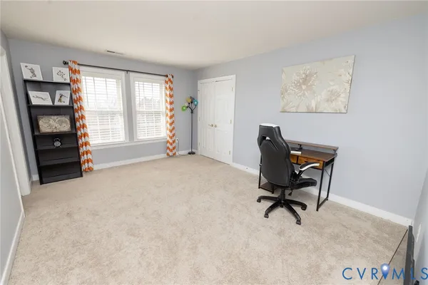 a bedroom with a bed and a television