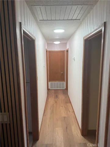 a view of hallway with wooden floor