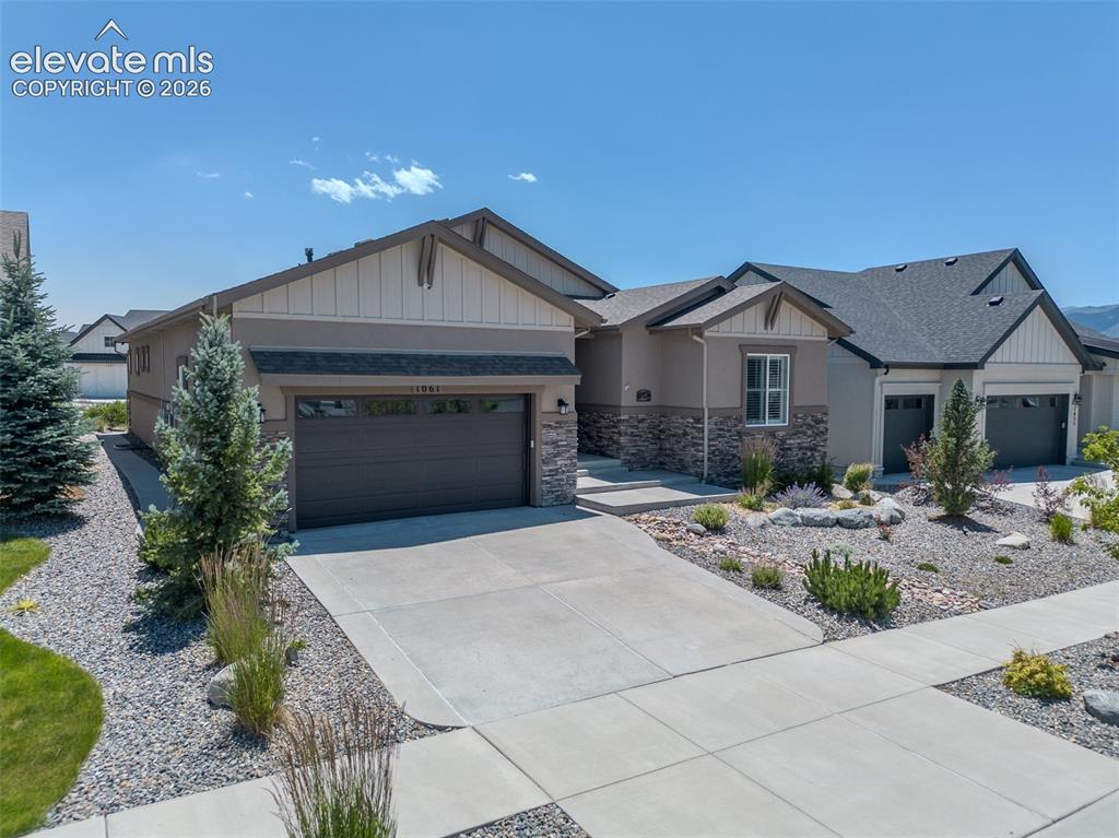 1061 Native Dancer Terrace Colorado Springs, CO 80921 - Photo 2 of 50 Contemporary ranch-style residence featuring a combination of stucco and stone veneer exterior