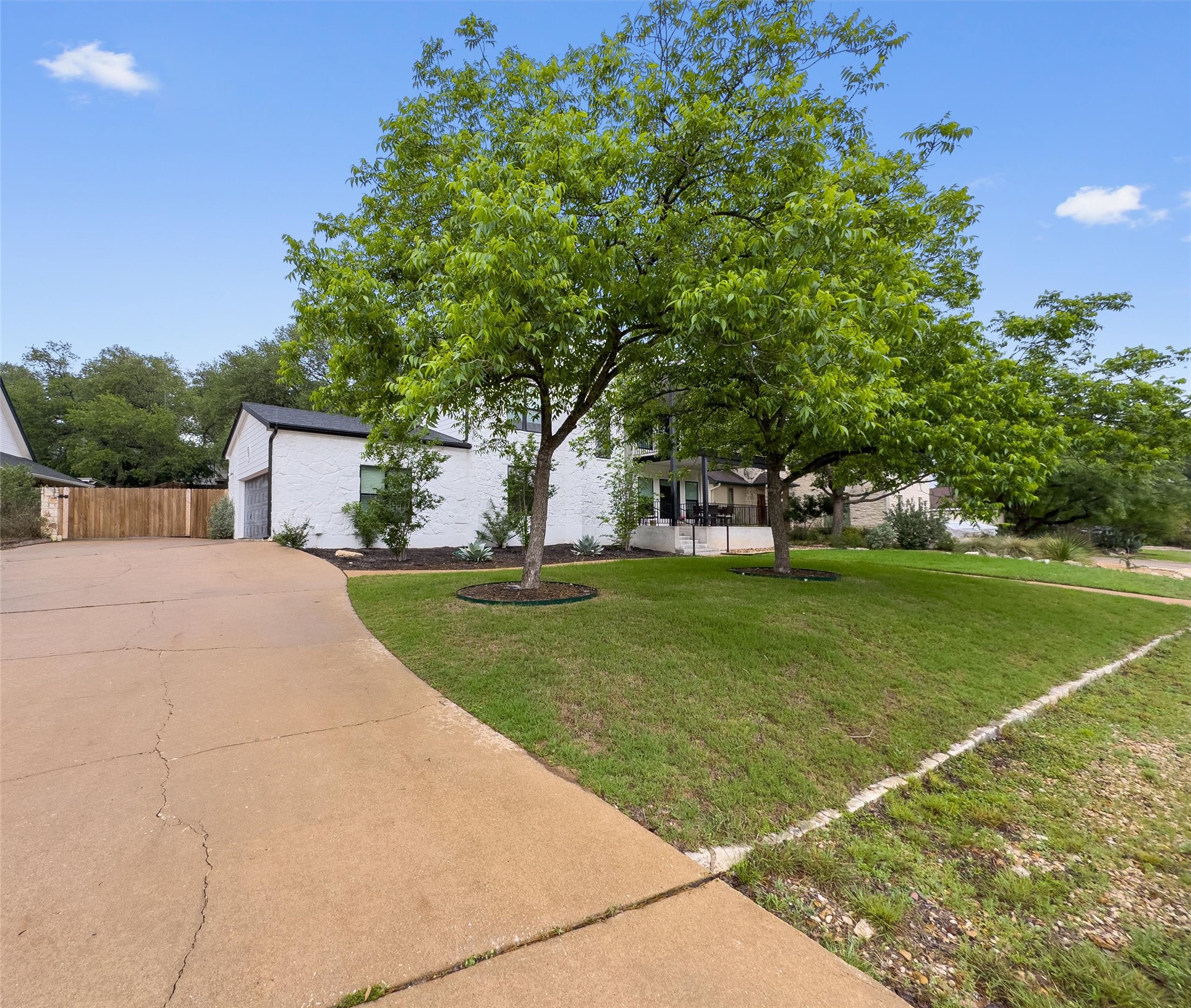 307 Hurst Creek Road Austin, TX 78734 - Photo 2 of 40 White brick exterior with black trim accents