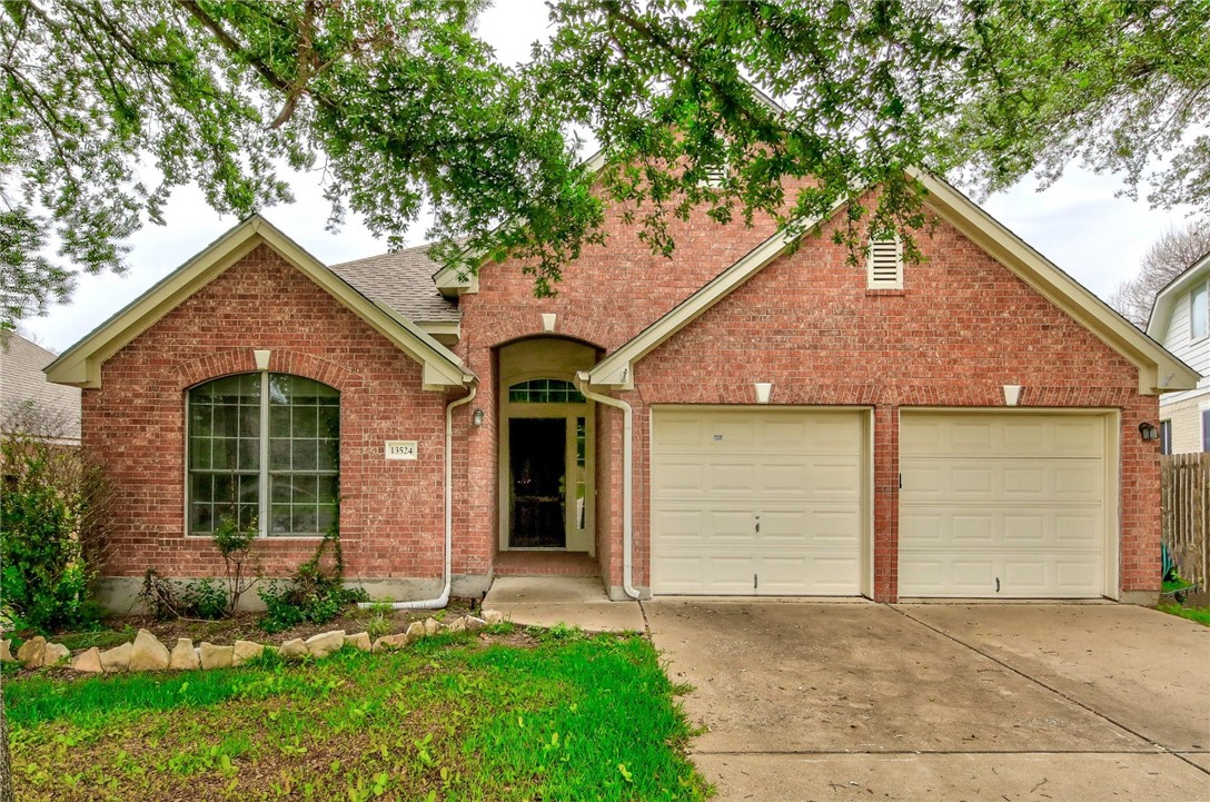 a front view of a house with a garden and plants