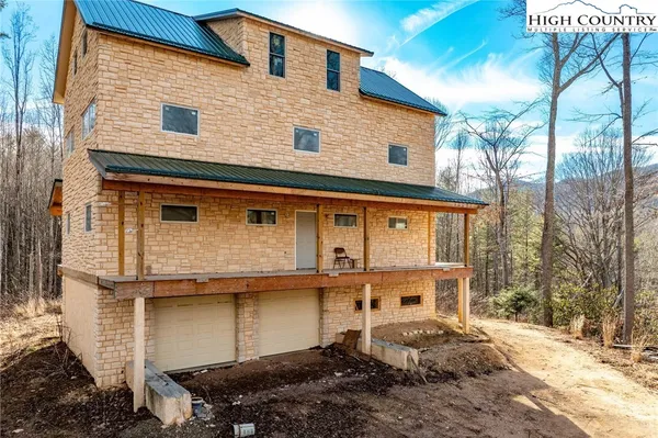 a front view of a house with parking space