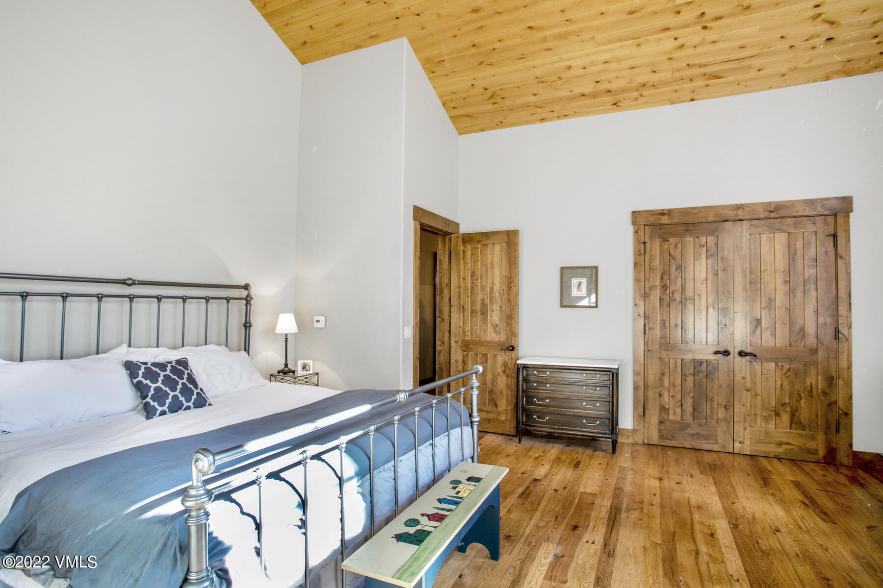 400 Red Draw Edwards, CO 81632 - Photo 30 of 49 a bedroom with a bed and wooden floor