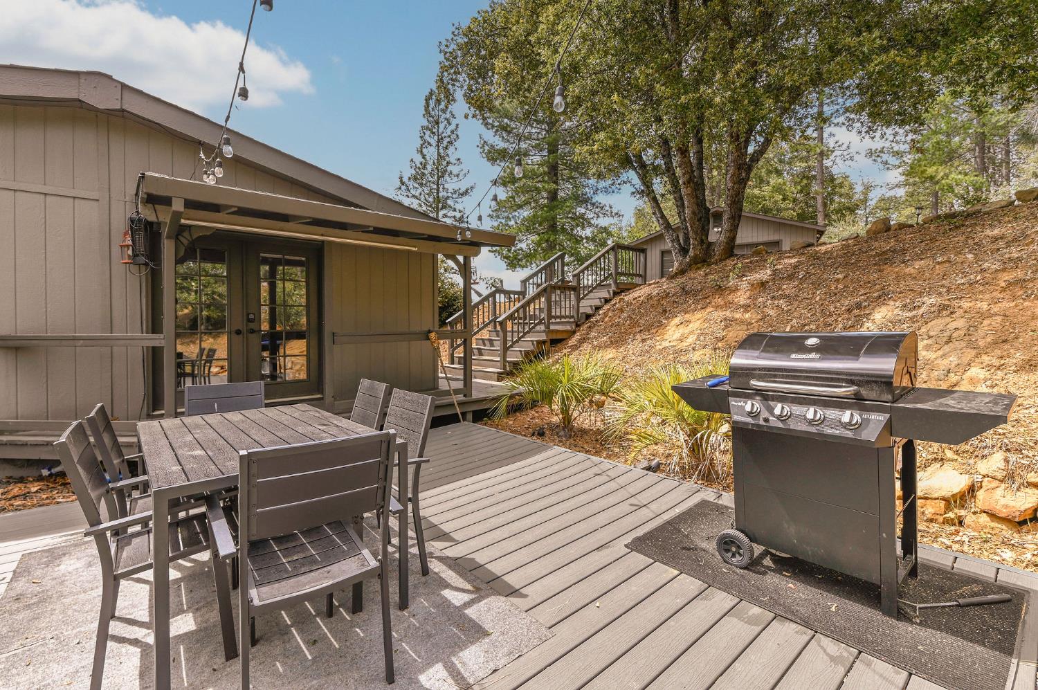 5695 Old Emigrant Trail Mountain Ranch, CA 95246 - Photo 45 of 79 a view of a patio with table and chairs with wooden floor and fence