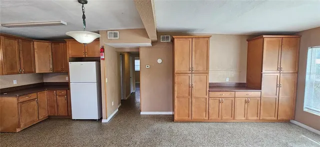 a view of a kitchen with stainless steel appliances granite countertop cabinets and a window