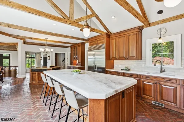 a kitchen with a stove a sink cabinets and wooden floor