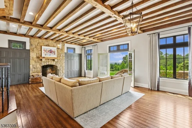 a living room with furniture fireplace and wooden floor
