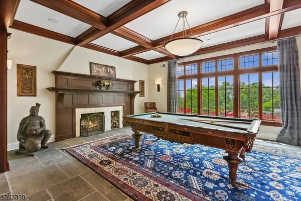 a living room with a couch a fireplace flat screen tv and a large window