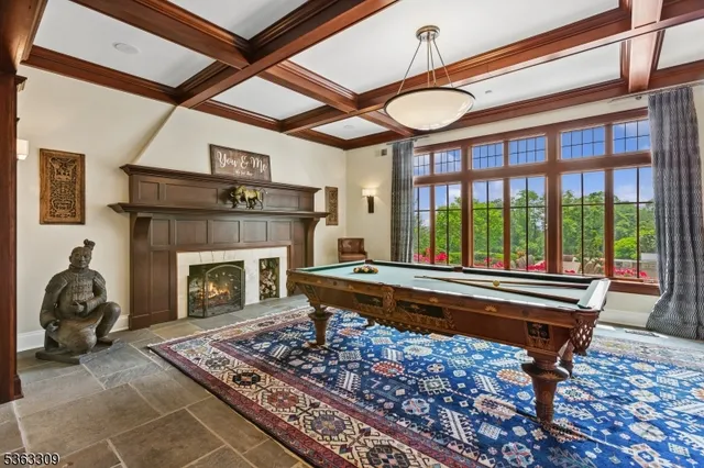 a living room with a couch a fireplace flat screen tv and a large window