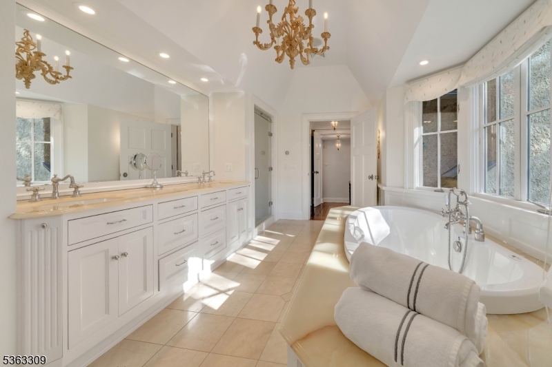 211 Private Road Bernardsville, NJ 07924 - Photo 34 of 50 a spacious bathroom with a granite countertop sink a mirror a vanity and bathtub