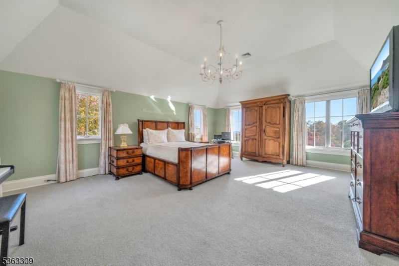 211 Private Road Bernardsville, NJ 07924 - Photo 36 of 50 a spacious bedroom with a bed and a chandelier