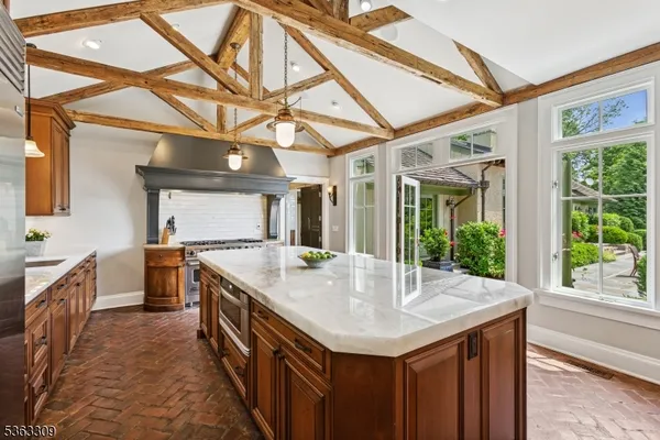a kitchen with a stove a sink and a wooden cabinets