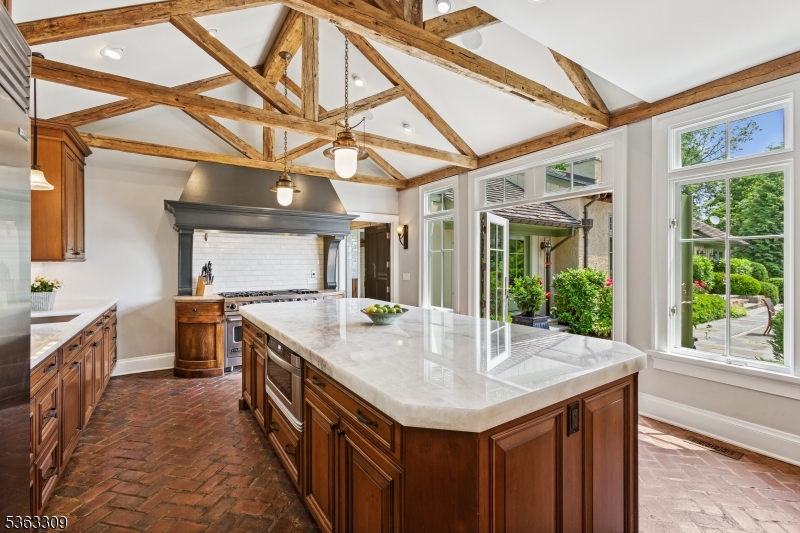 211 Private Road Bernardsville, NJ 07924 - Photo 7 of 50 a kitchen with a stove a sink and a wooden cabinets