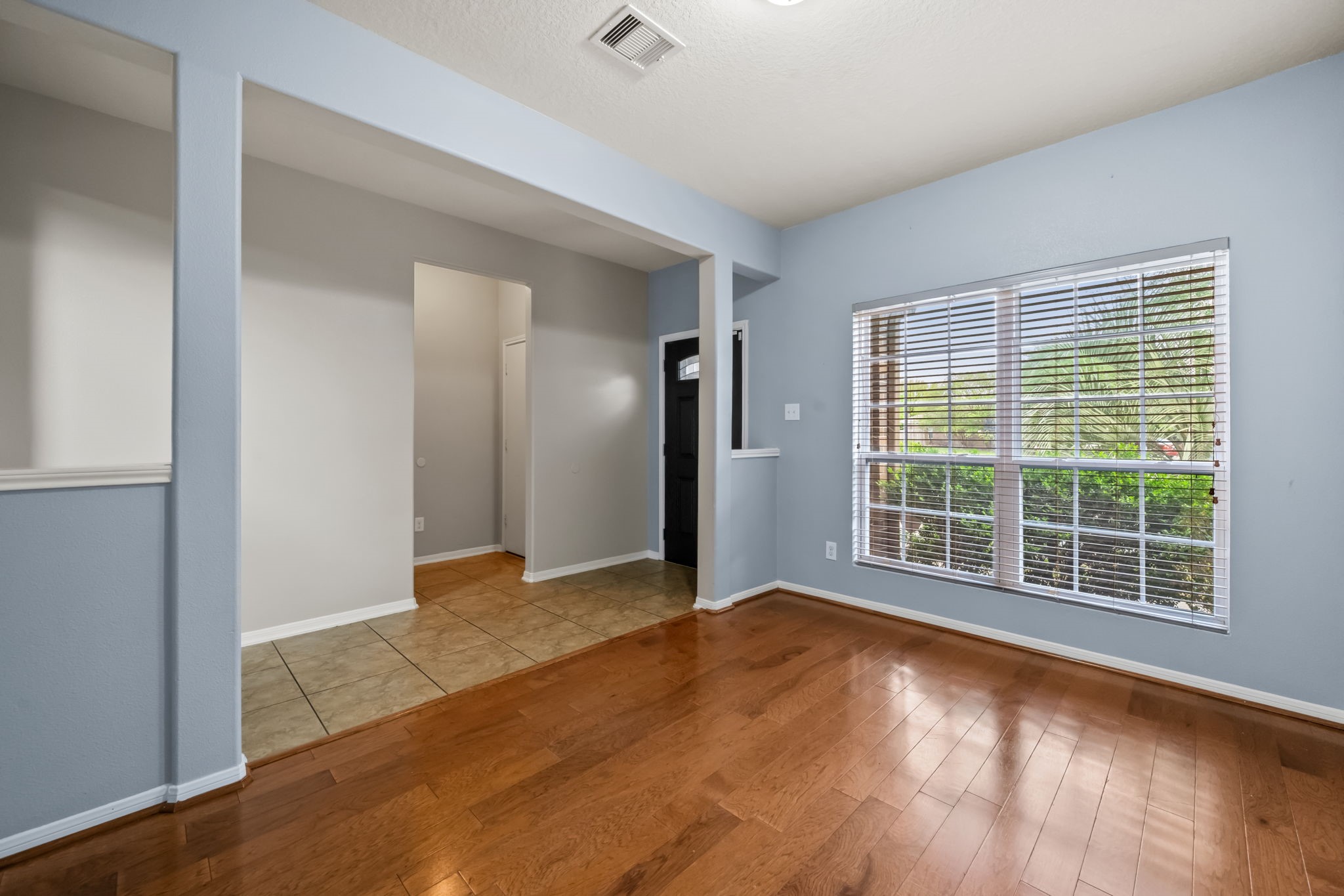 903 Northgate Springs Drive Spring, TX 77373 - Photo 3 of 36 an empty room with wooden floor and windows