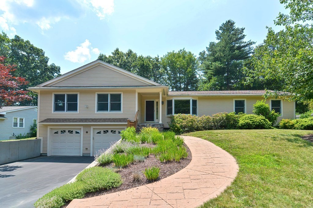 a front view of house with a garden