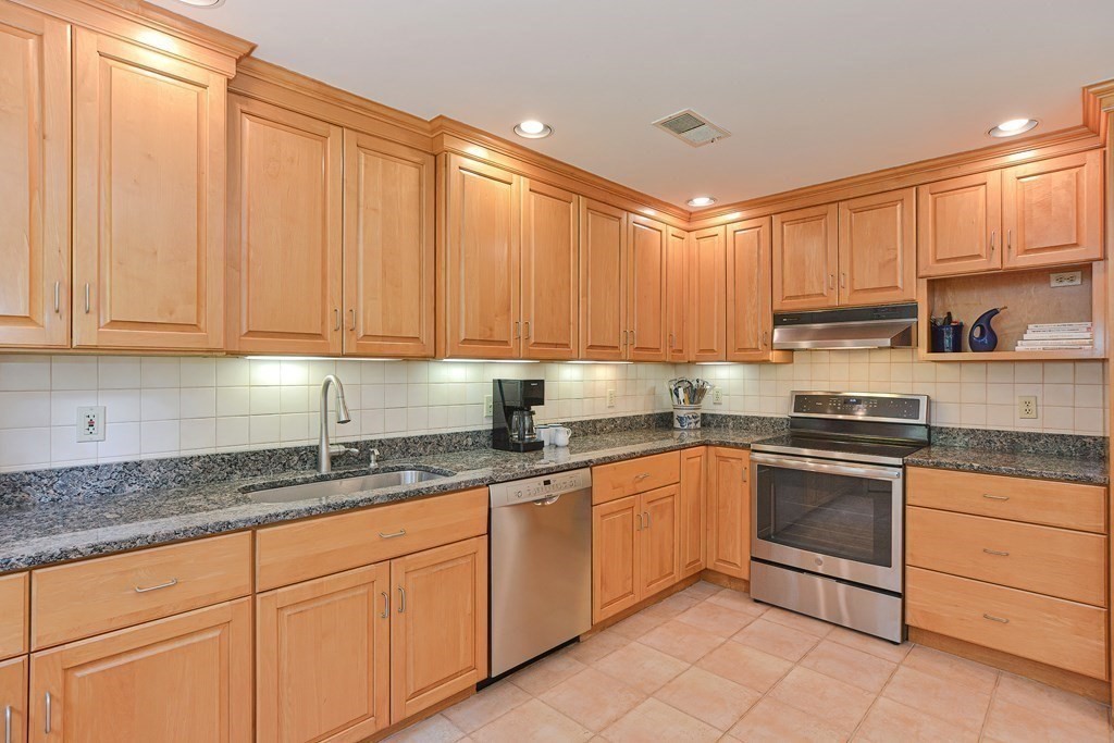 110 Richard Road Holliston, MA 01746 - Photo 15 of 41 a kitchen with granite countertop white cabinets stainless steel appliances and a sink