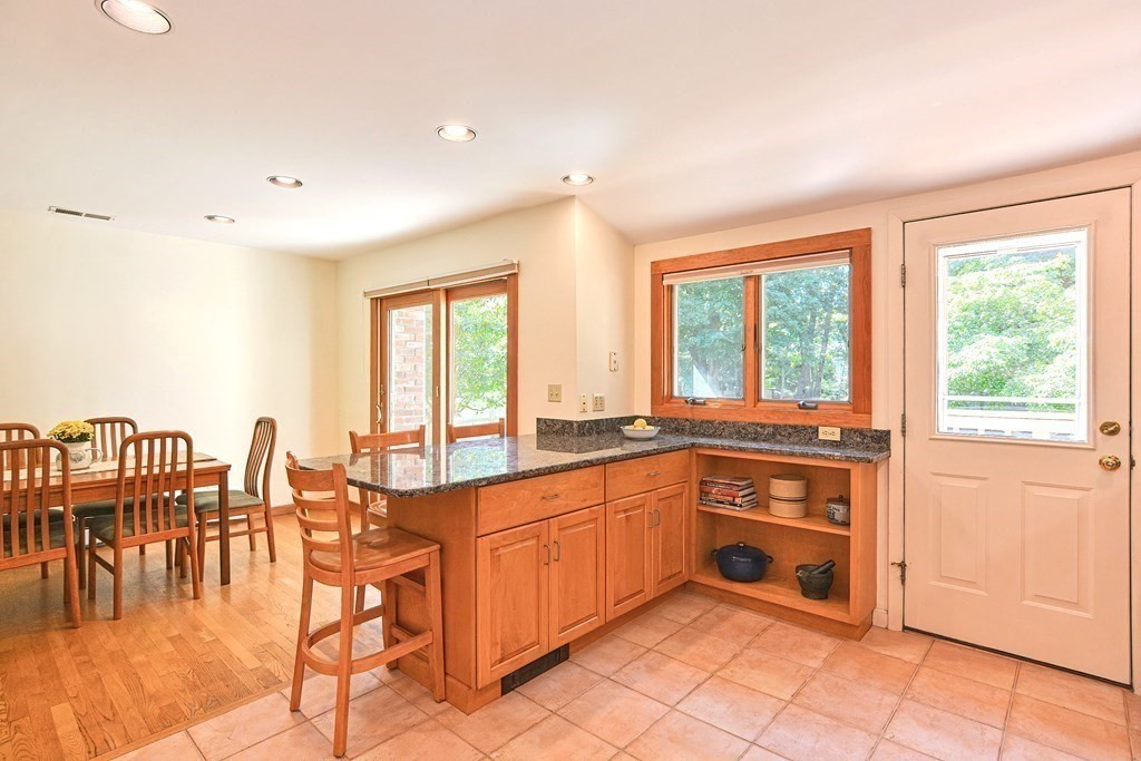 110 Richard Road Holliston, MA 01746 - Photo 17 of 41 a large kitchen with lots of counter top and dining table