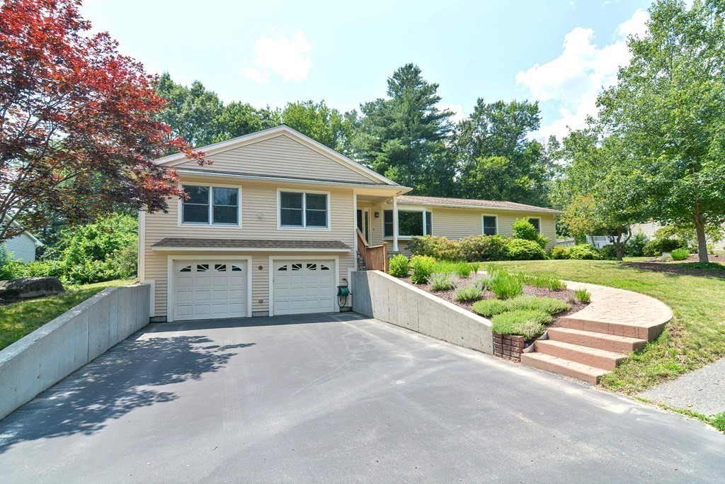 110 Richard Road Holliston, MA 01746 - Photo 2 of 41 a front view of a house with a yard and potted plants