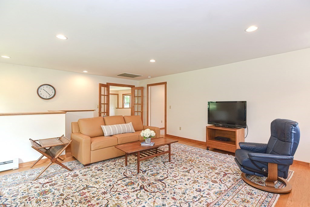 110 Richard Road Holliston, MA 01746 - Photo 21 of 41 a living room with furniture and a flat screen tv