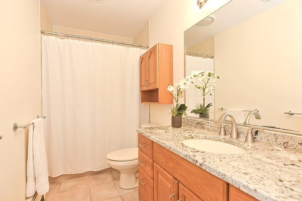 110 Richard Road Holliston, MA 01746 - Photo 36 of 41 a bathroom with a granite countertop sink toilet and shower